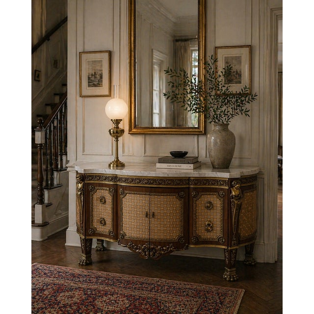 An exceptional antique French marble top sideboard cabinet of large proportions, crafted in mahogany and richly adorned...