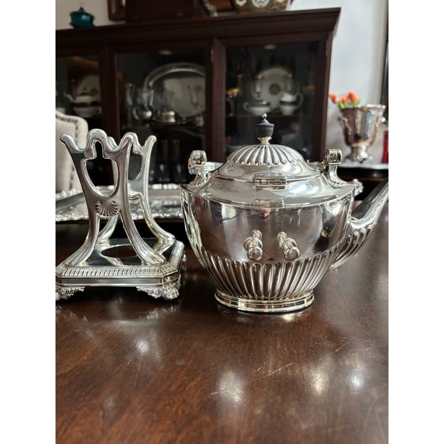 Gorgeous 1964 Tiffany & Co. art deco silver soldered tilting teapot service. Fluted design with black bake lite handle and...