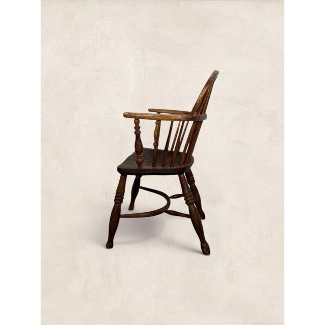 Antique English Oak Windsor 19th Century Chair A Windsor armchair with a pierced central splat and swept arms that somehow...
