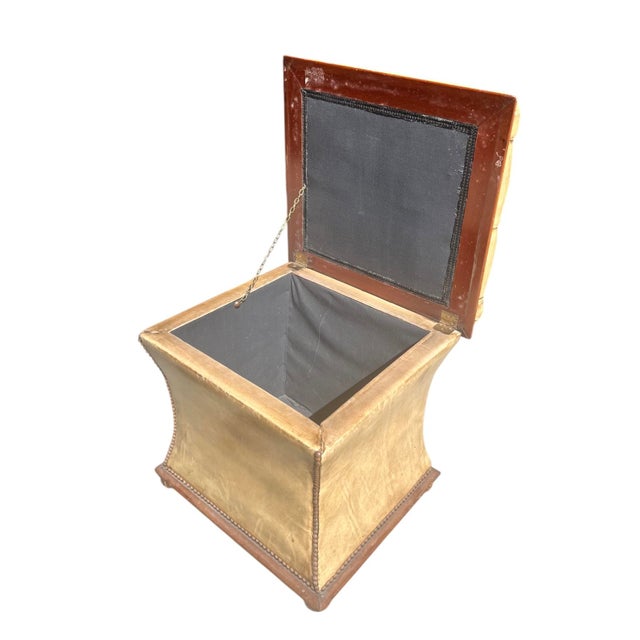 A handsome antique English leather storage ottoman, in an interesting buckskin or camel color, with deeper brown accents...