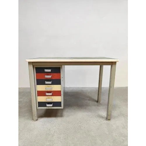 You rarely come across this cheerful steel desk from gispen. Period: 1950s. Crazy multi-color drawers and a sleek dark...
