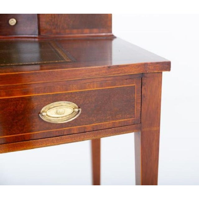 This pretty Bonheur du Jour is raised upon elegant tapered legs Featuring 1 mahogany lined drawer and a leather writing...