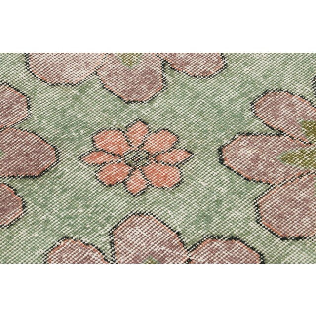 Made with hand-knotted wool circa 1950-1960, this 5x8 vintage Turkish rug of all over floral medallion design is an...