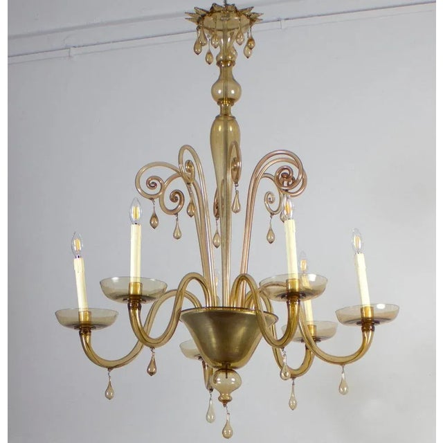 This elegant amber color chandelier features 6 arms . Cleaned and re-wired, in full working order and ready to use. In...