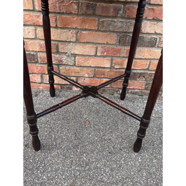 This is an antique George III style or mahogany side table. It features an octagonal top with a single drawer and turned...