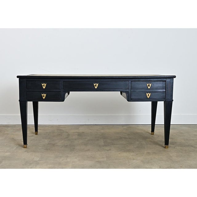 A French, 19th century Directoire style leather-topped desk with hidden extensions on each side to add surface area, in a...