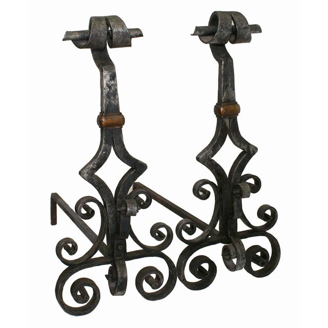 Antique, early 20th century hand wrought andirons. Scroll and concave lozenge design.