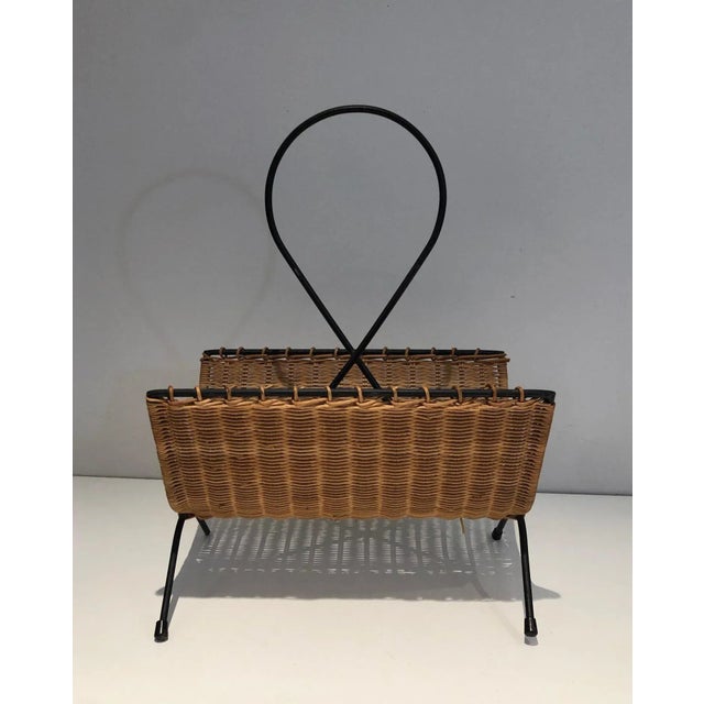 This black lacquered magazine rack is made of metal. This is a French work. Circa 1950.