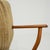A set of three mid-century modern armchairs with wooden frames and upholstered seats. The design features clean lines and...