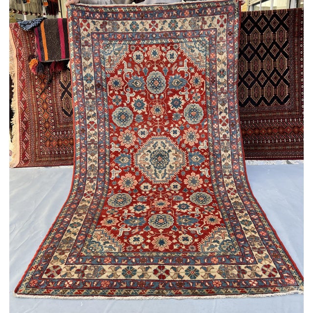 Persian Karaja design hand-knotted rug featuring a central diamond medallion in ivory and slate blue, surrounded by large...