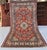Persian Karaja design hand-knotted rug featuring a central diamond medallion in ivory and slate blue, surrounded by large...