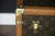 This charming little Louis Vuitton travel trunk is adorned with a hand-painted stencil monogram, honey-colored "lozine"...