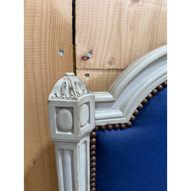 A louis xvi style headboard and footboard in carved wood, painted gray and white, stamped with the mark of a parisian...