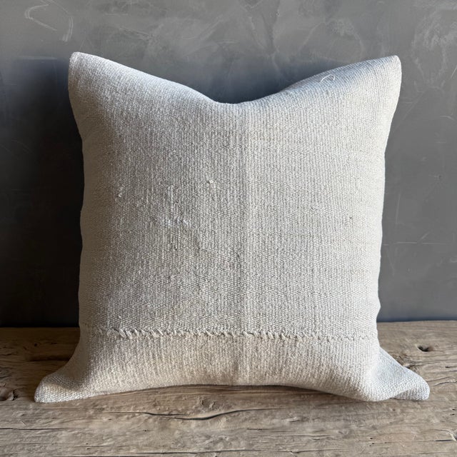 Creamy white hemp rug pillow with original seams. Soft hand, linen blend backing with zipper closure. Spot cleaning is...