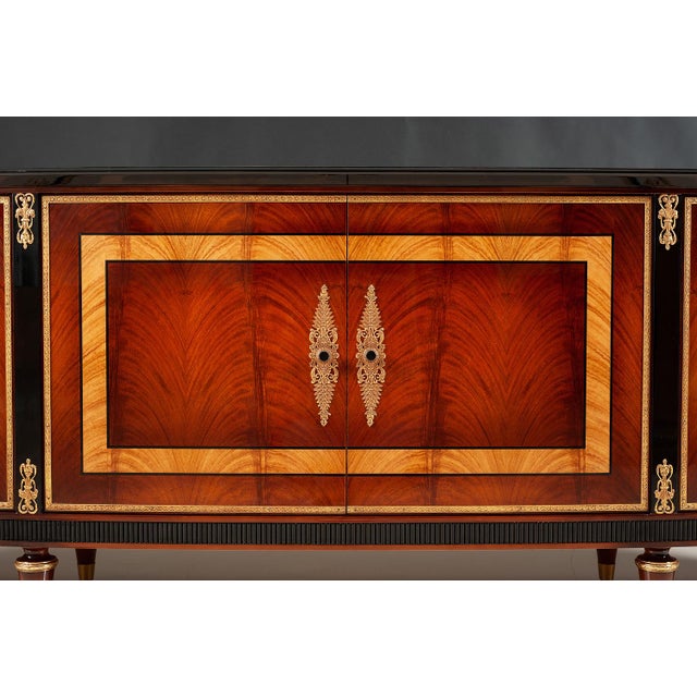 Handcrafted in Spain, this sideboard features Bohemian rosewood and oak burl veneers arranged in striking geometric...