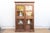 This 70-inch tall cabinet is a classic example of British Colonial furniture from the early 20th century. It features a...
