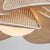 Petals of natural rattan caning are trimmed in white cotton and layered around an opal glossy glass globe to give Florina...