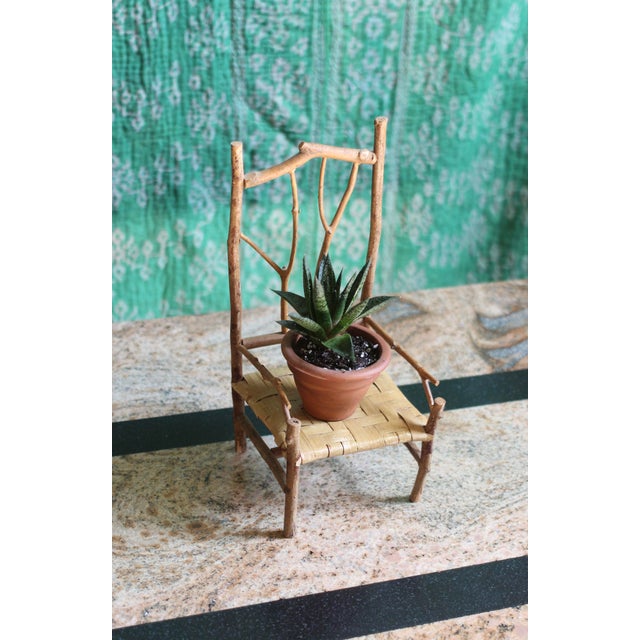 Small doll chair perfect for seating plants or for a children's room for toys. Twig/branch primitive arms and back with a...
