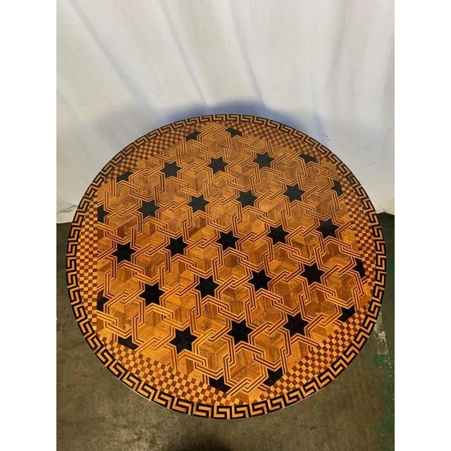 A fine walnut and parquetry inlaid william iv style centre table. Late 19th century. The circular top inlaid with...