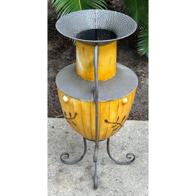 Southwestern style hammered tin urn on metal stand, all one piece. Great saffron yellow color. Use this decorative piece...