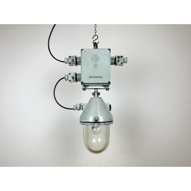Grey industrial explosion proof light with massive protective glass bulb. Made in former Czechoslovakia by Elektrosvit...