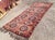 This gorgeous hand knotted vintage Anatolian runner rug is approximately 70 years old in excellent vintage condition. The...