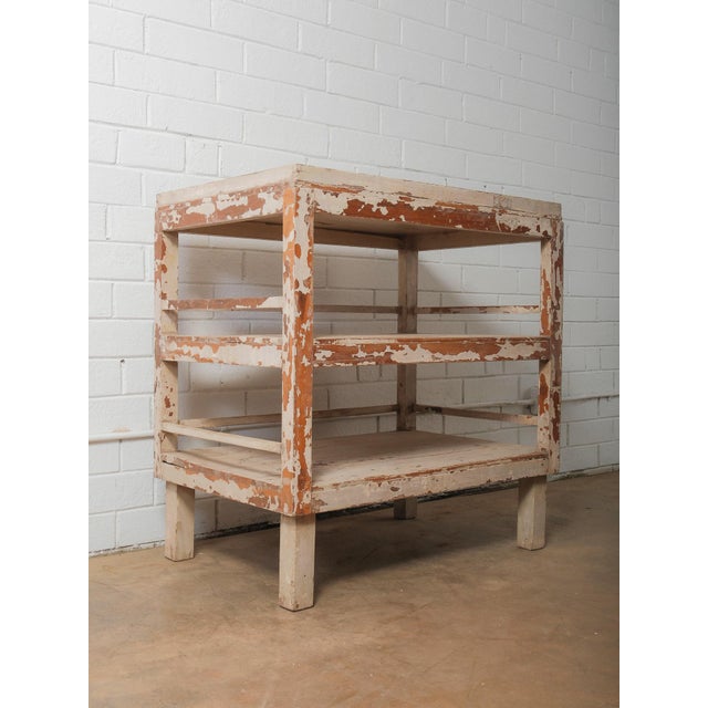 This Indian wooden shelving table features a strong, utilitarian form highlighted by its beautifully aged, original...