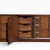 An expansive Mid-Century Modern lowboy dresser featuring a striking Brutalist-inspired facade. Crafted in a rich, dark-...