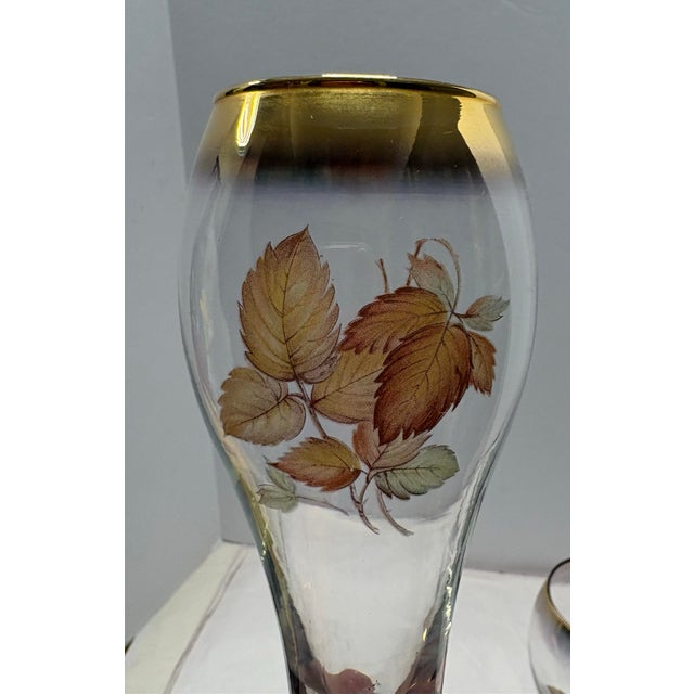 Elegant vintage champagne flutes featuring a softly graduated gold rim, gilded stem and foot, and a delicate autumn leaf...
