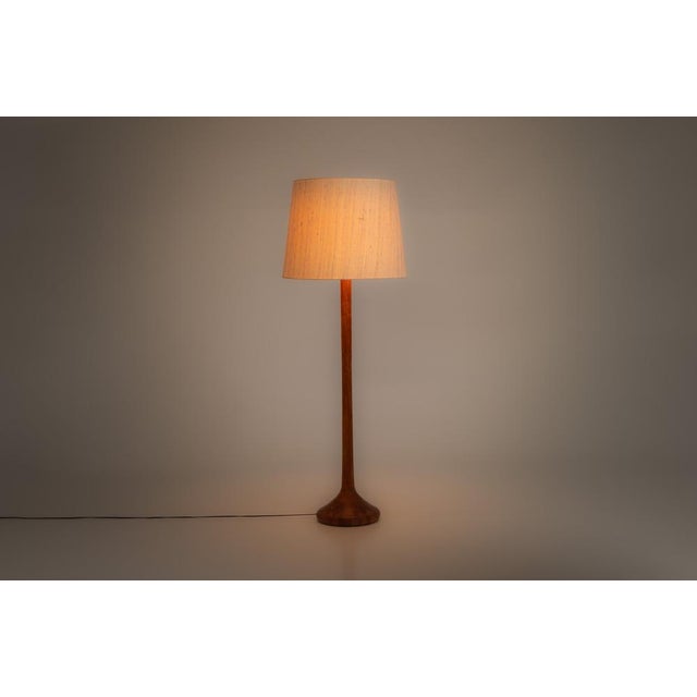 Vintage floor lamp in teak, produced in Denmark by Domus. This elegant Scandinavian design features an organic conical...