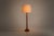 Vintage floor lamp in teak, produced in Denmark by Domus. This elegant Scandinavian design features an organic conical...