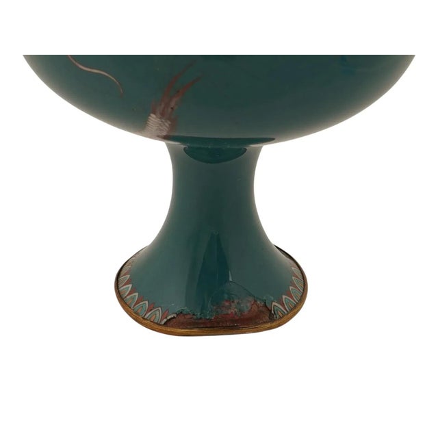 An antique Japanese late Meiji era vase of a baluster shape with a narrow fluted neck. The metal vase is adorned with a...