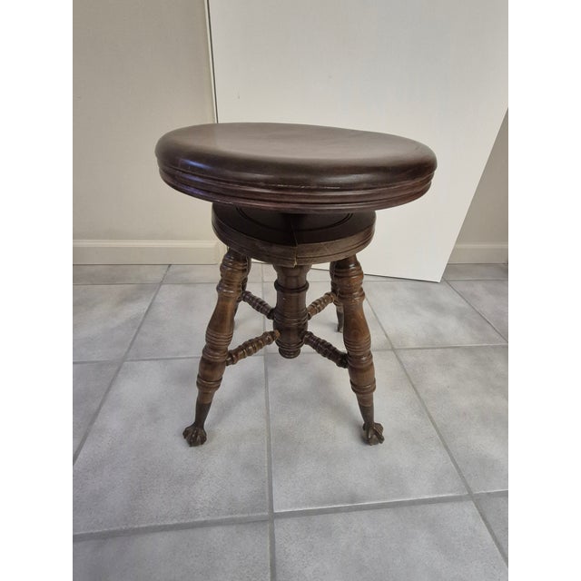 This is an antique Victorian-style adjustable swivel piano stool, typically dating from the late 19th century to early...