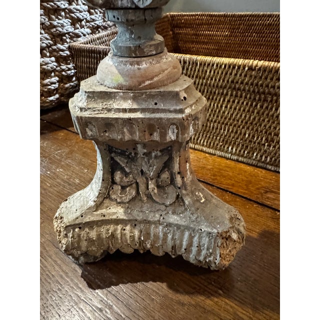 This is an 18th-century Italian carved wooden altar stick featuring a rustic, gracefully aged patina.