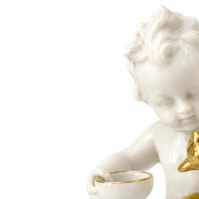 Porcelain - Boy with dog. Molded porcelain sculpture from East Germany; gold decoration. Slight wear on the gold plating....