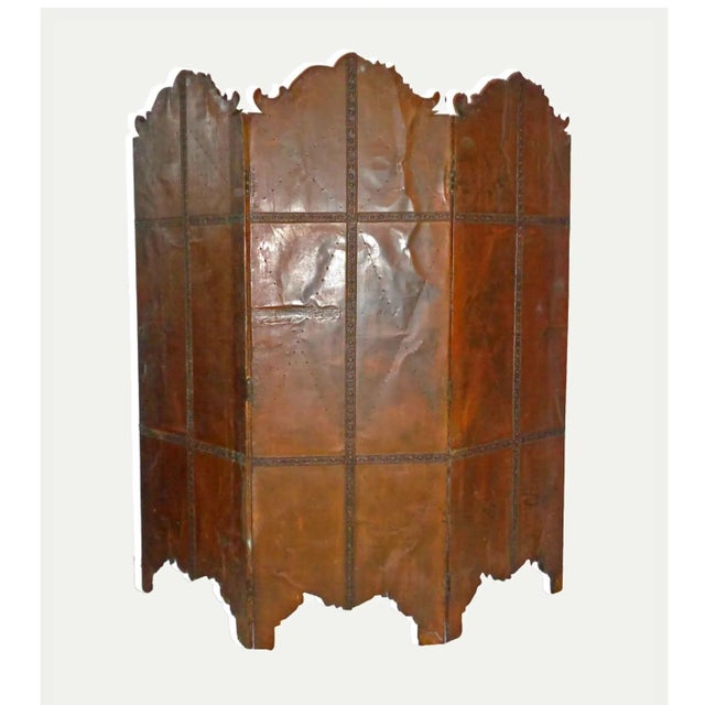 Ornate, Tudor Revival style brass repousse folding screen. Upper section consists of central panel with "Tudor Rose" motif...