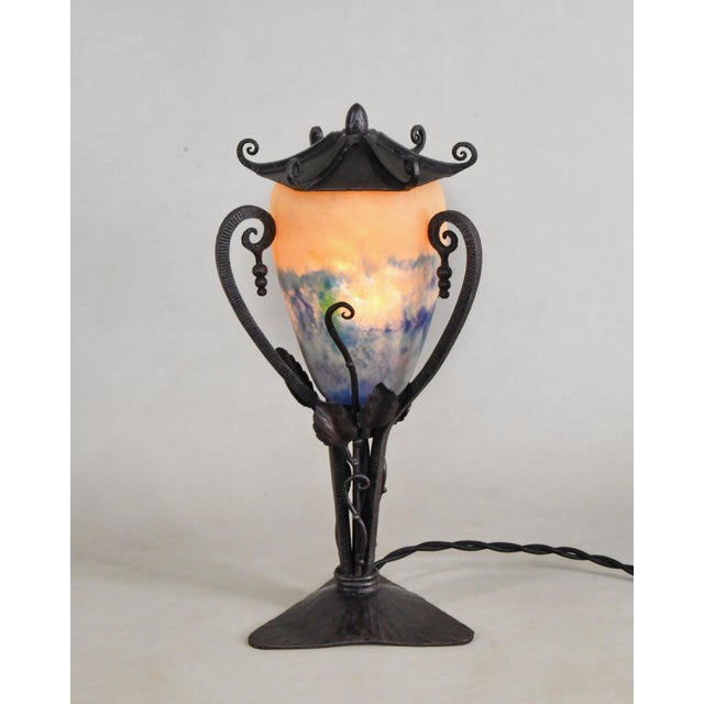 Edmond Gauthier & Daum An elegant 1925-1935 Art Deco lamp in wrought iron with a pâte de verre shade signed Daum Nancy...