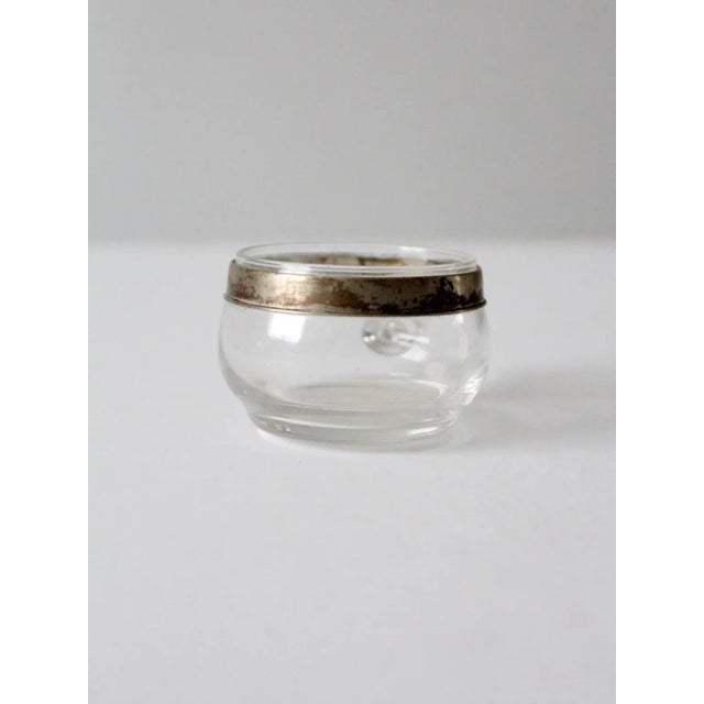 This vintage glass cup, in the style of Dorothy Thorpe, features a softly bulbed bowl with a straight glass handle and a...