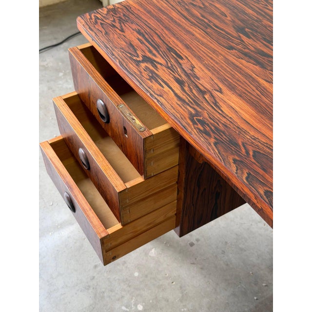 Beautiful Mid Century Modern Danish desk crafted in richly grained rosewood, featuring dramatic bookmatched patterns and...