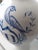 The "Diascord" Vase has a welcoming design of cobalt blue birds and flower vines adorning the top front. A childs face...