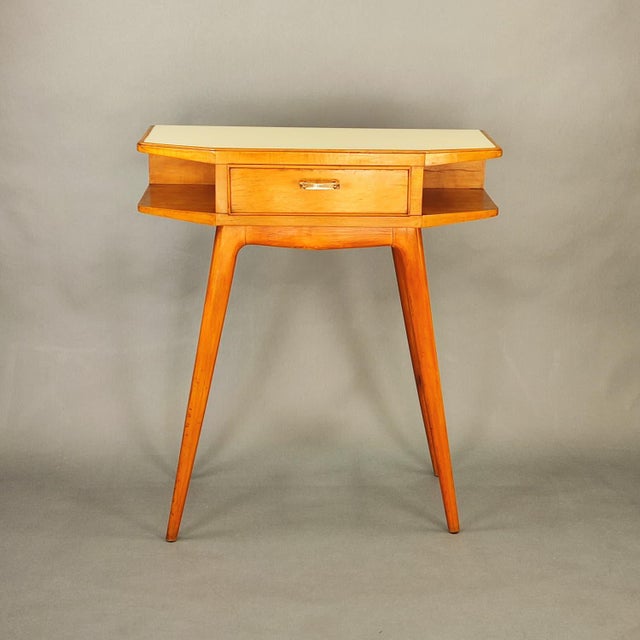 Small and versatile entryway console table with drawer, Italian design from the 1950s. Beech wood frame, ivory white glass...