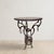 A distinctive handmade round side table featuring an ornate wrought iron base and a solid wooden top. Combining decorative...