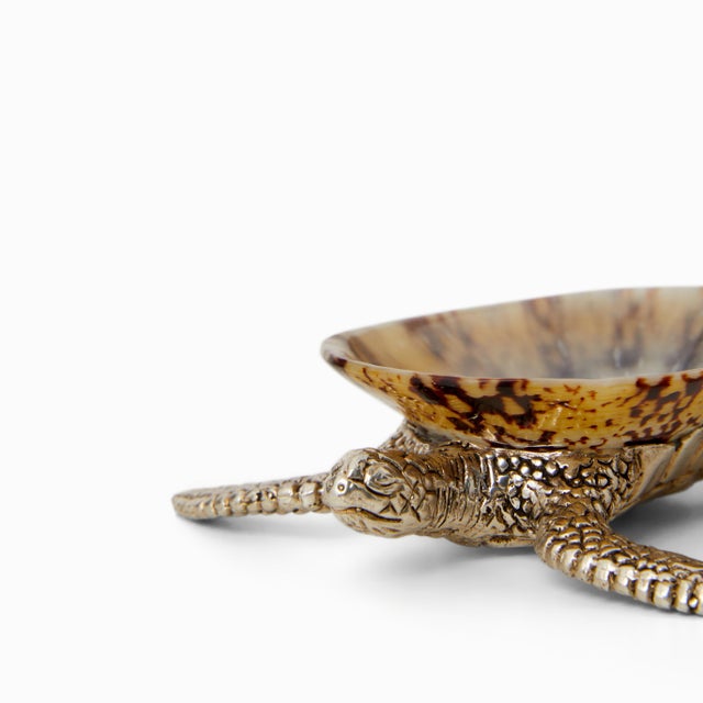 Seashell condiment trays, carried through the waves and across the tablecloth by silver turtles. Dainty mother-of-pearl...