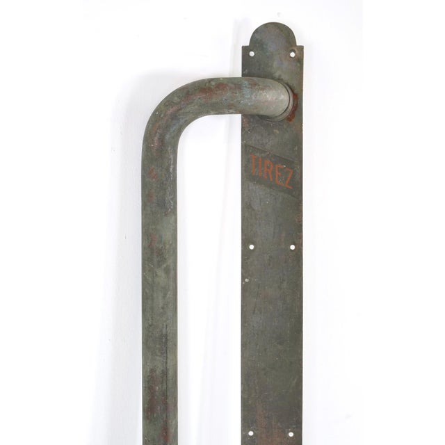 Vintage European door pull handle made of darkened brass with the bent handle positioned left. The original mounting...
