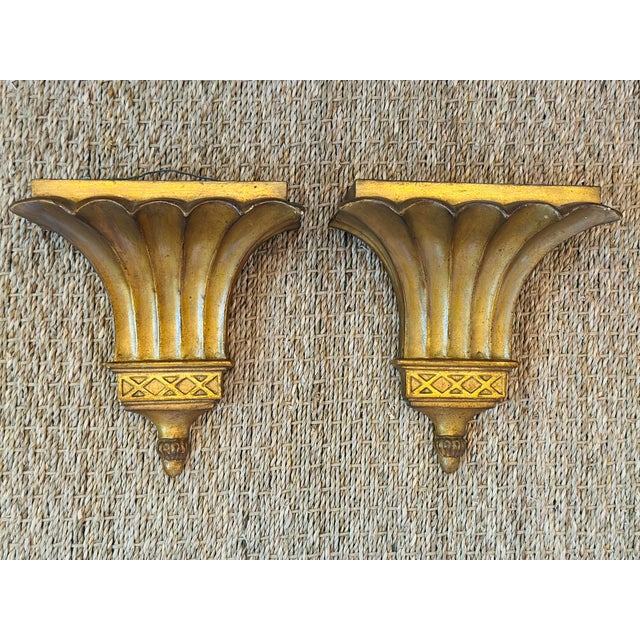 These are a handsome pair of vintage Hollywood Regency-style gilt wall brackets (wall shelves) with a dramatic...