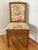 Vintage pencil reed side chair in a warm honey tone. Upholstered in cream fabric with pink, sage, and blue botanicals. In...
