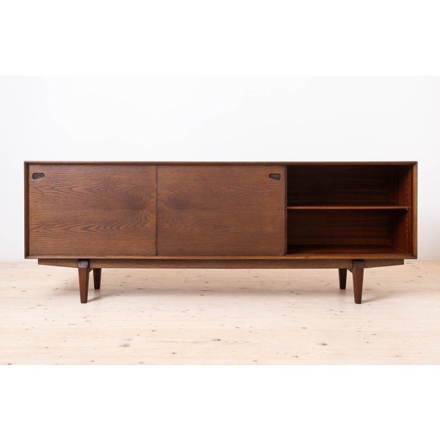 Sideboard by skovby møbler, model no. 65 in chocolate brown stained oak wood with sliding doors and 5 drawers, a great...