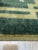 Sloane Louie Green Hand Knotted Wool Rug, Country of Origin: China. This exceptional piece presents a striking modernist...