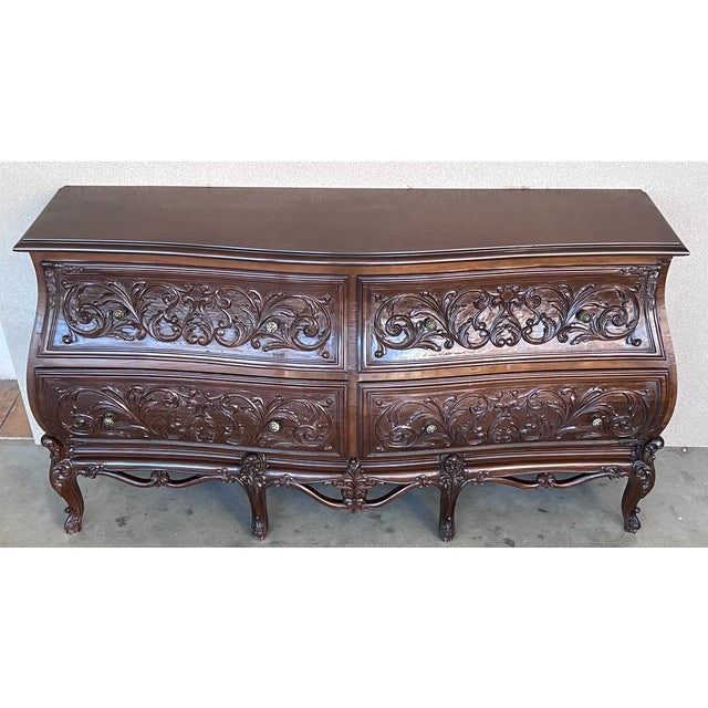 A finely carved late 20th century walnut commode in the French provincial Louis XV style particular to Nimes. The commode...