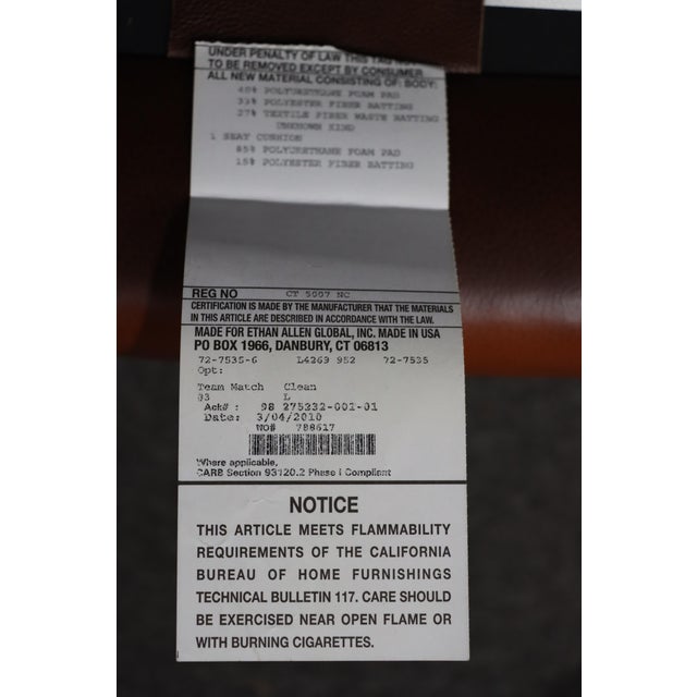 Classic leather wingback chair by Ethan Allen, featuring a tall shaped back with gently flared wings and rolled arms....